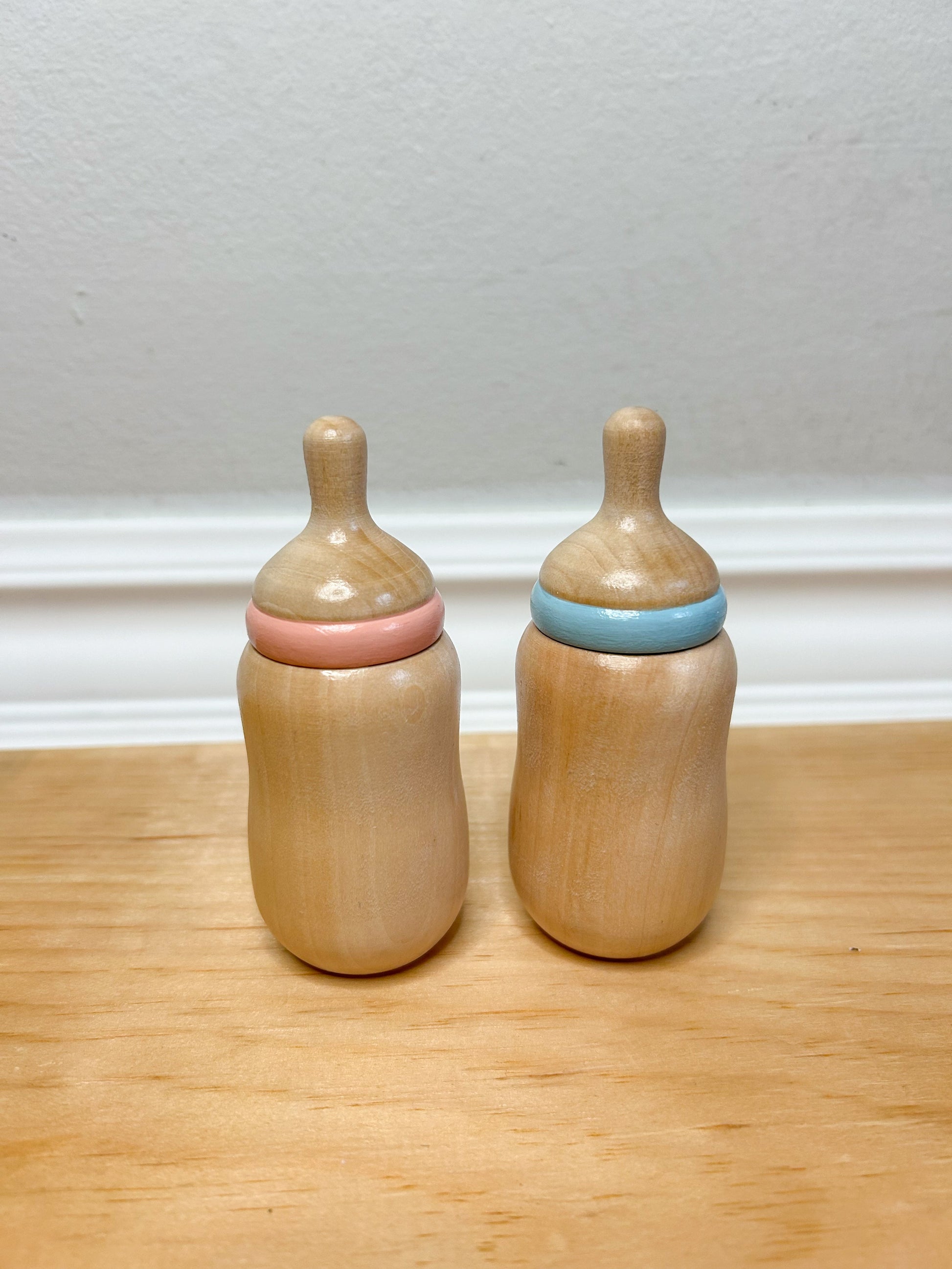 wooden baby doll bottle in pink and blue