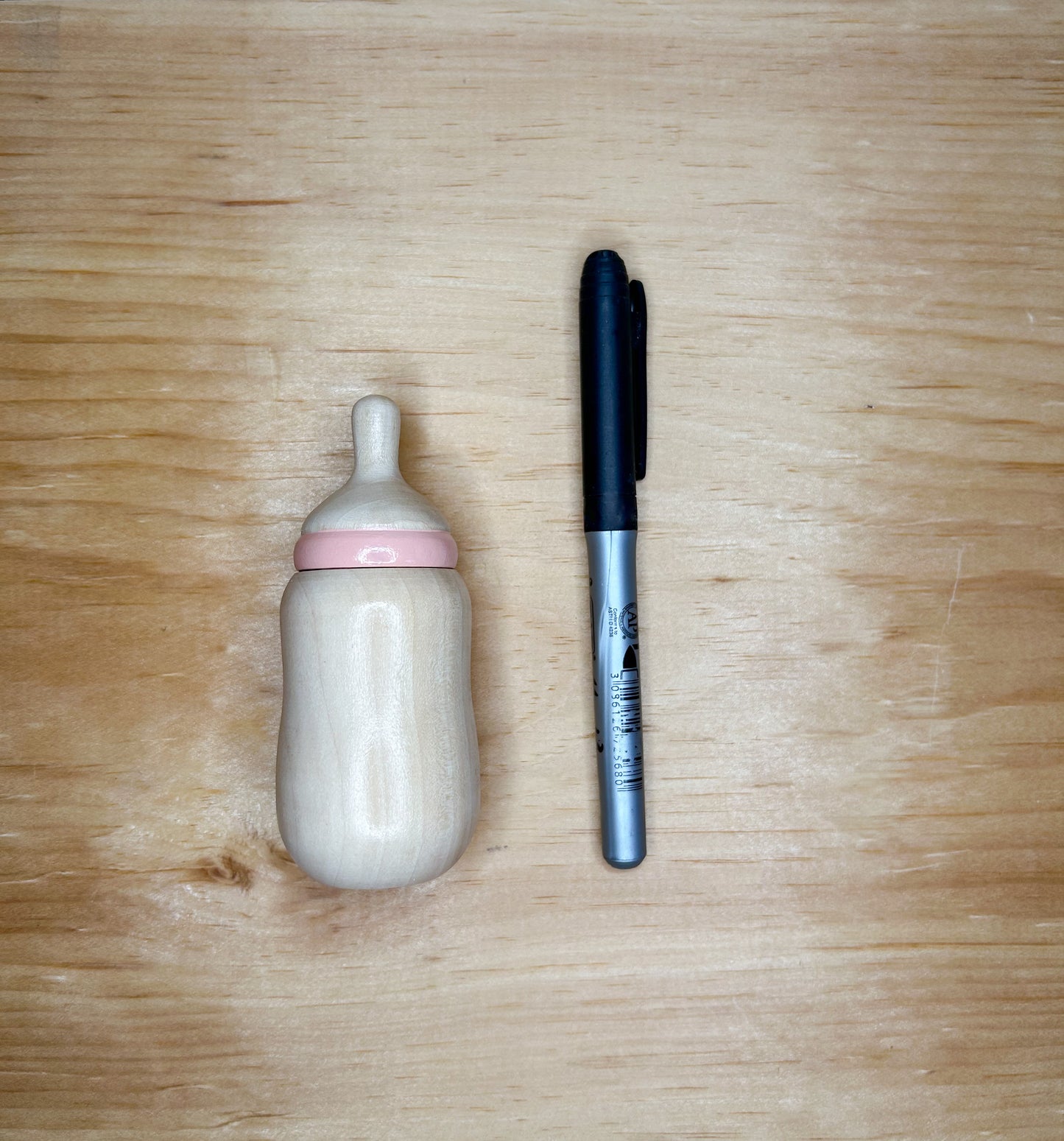 size comparison of wooden baby doll bottle and sharpie 