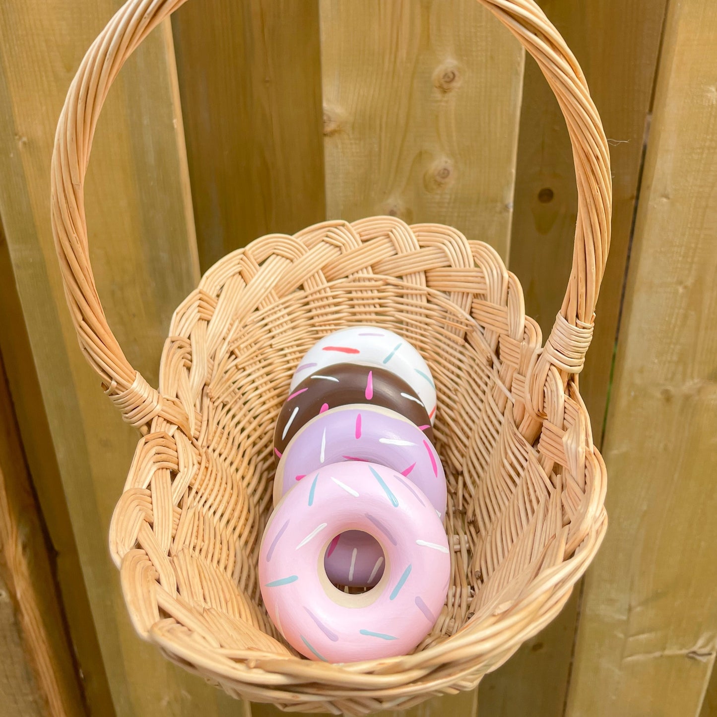 wooden donut toys in basket 